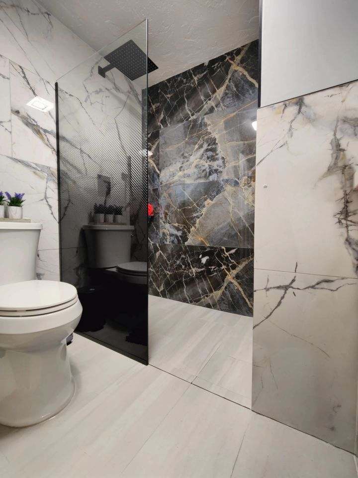 Marble tile bathroom with glass shower